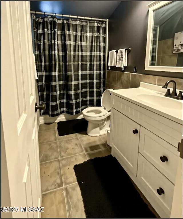 6902 E Calle Neptuno, Tucson, AZ 85710 - bathroom featuring tile patterned floors, tile walls, toilet, vanity, and shower / bath combo