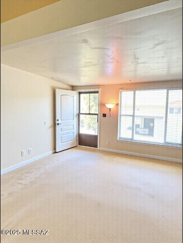 6902 E Calle Neptuno, Tucson, AZ 85710 - unfurnished room featuring light carpet and baseboards