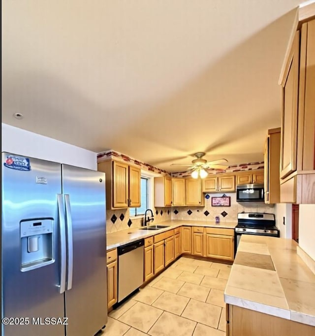 6902 E Calle Neptuno, Tucson, AZ 85710 - kitchen featuring stainless steel appliances, a sink, light countertops, and tasteful backsplash