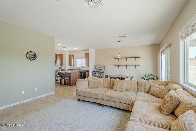 living area featuring recessed lighting, baseboards, visible vents, and light colored carpet
