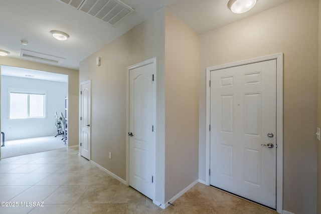 entrance foyer with baseboards, light tile patterned flooring, and visible vents