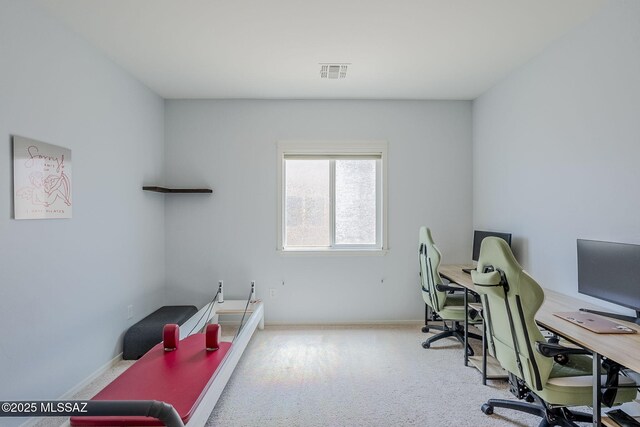 office space with baseboards, visible vents, and carpet