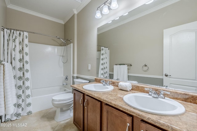 bathroom featuring double vanity, toilet, ornamental molding, and a sink