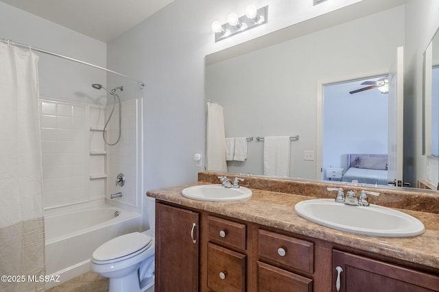 full bath with double vanity, a sink, connected bathroom, and toilet