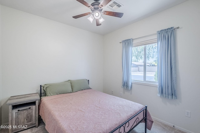 bedroom with baseboards, ceiling fan, carpet flooring, and visible vents
