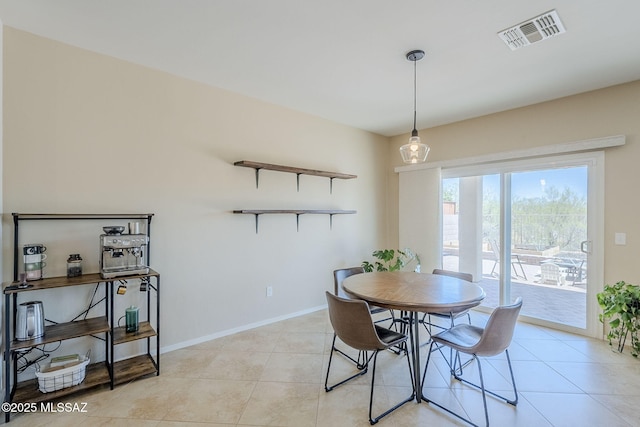 dining room featuring light tile patterned floors, baseboards, and visible vents