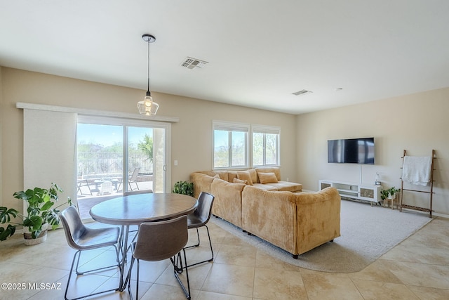 living area with visible vents and light tile patterned floors