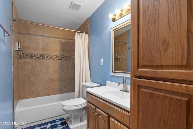 bathroom featuring shower / bath combo, vanity, visible vents, and toilet