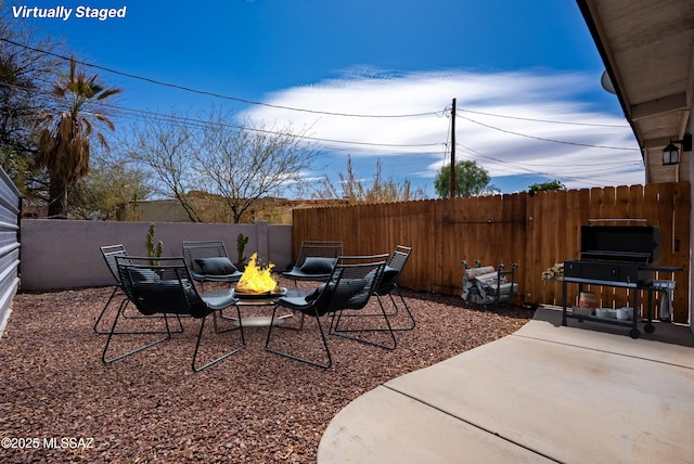 view of patio / terrace with a fenced backyard and an outdoor fire pit