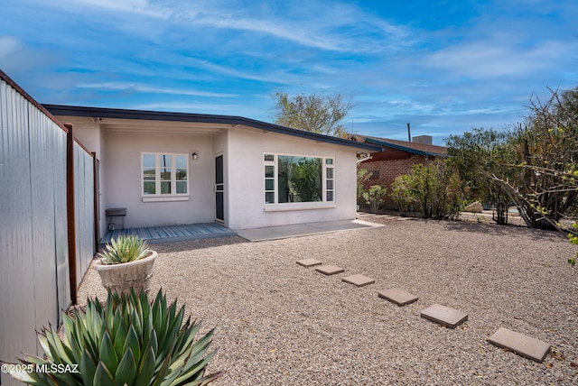 rear view of property with stucco siding