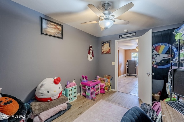 playroom featuring baseboards, wood finished floors, and ceiling fan