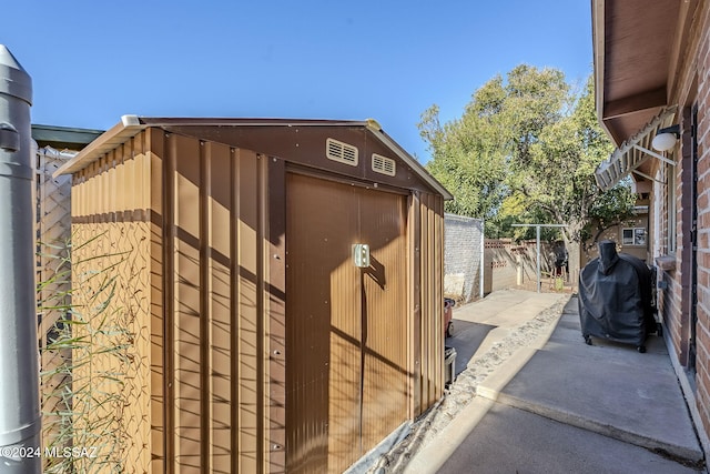 view of outdoor structure with an outbuilding and fence