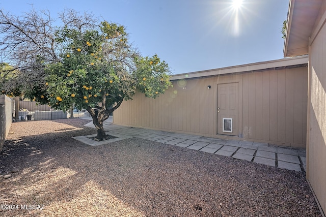 view of yard with fence and a patio
