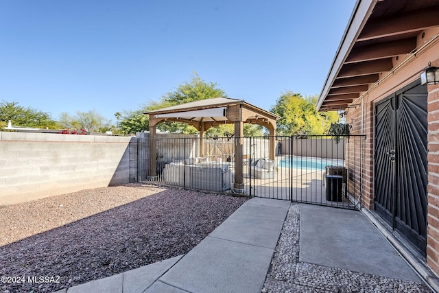 view of yard with a fenced backyard, a gazebo, and a patio