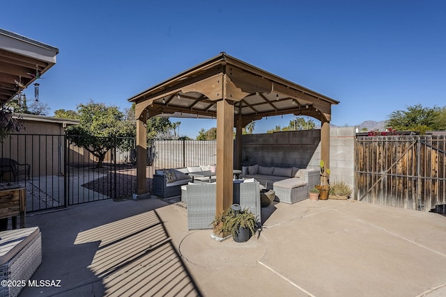 view of patio featuring an outdoor living space, a fenced backyard, and a gazebo