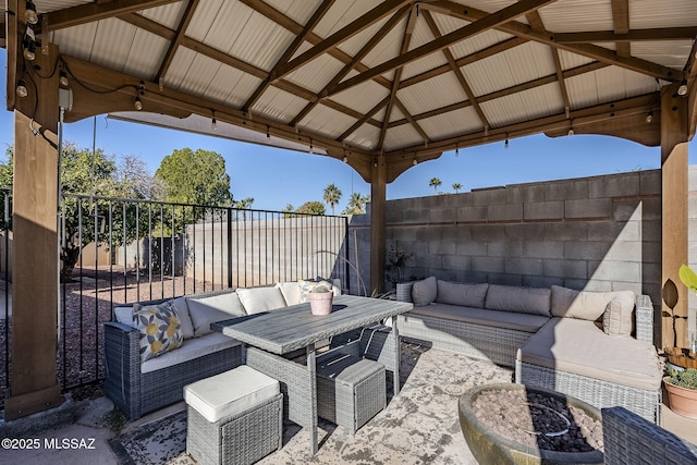 view of patio / terrace featuring a fenced backyard, an outdoor hangout area, and a gazebo