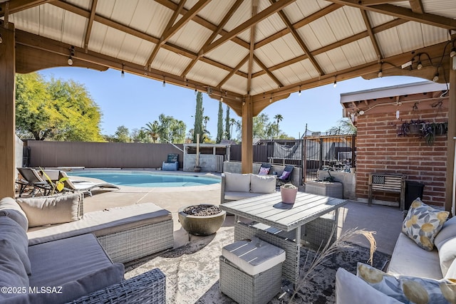 view of patio / terrace featuring outdoor lounge area, a gazebo, a fenced backyard, and a fenced in pool