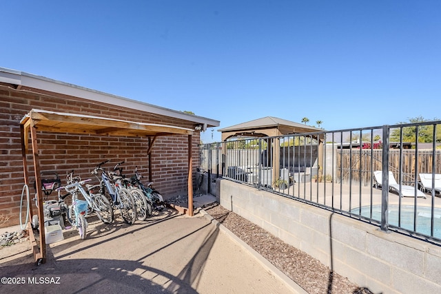 view of patio featuring fence and a gazebo