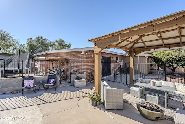 view of patio with fence, a gazebo, and an outdoor living space