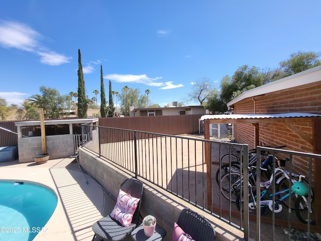 outdoor pool with a fenced backyard and a patio area