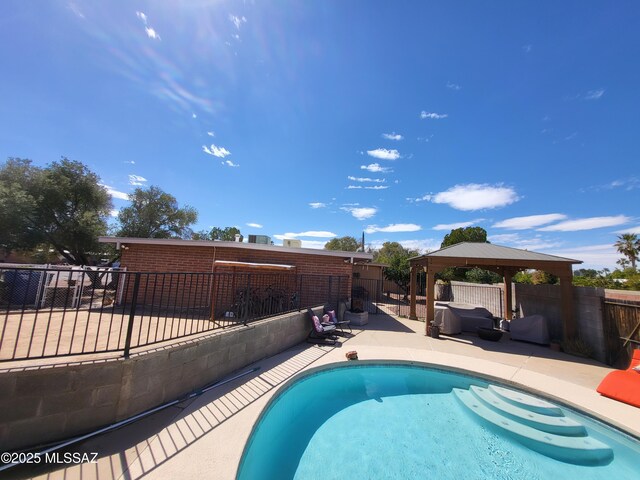 view of swimming pool featuring a fenced in pool, a fenced backyard, a gazebo, and a patio area