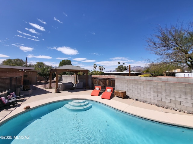 view of pool with a fenced backyard, a fenced in pool, a gazebo, and a patio