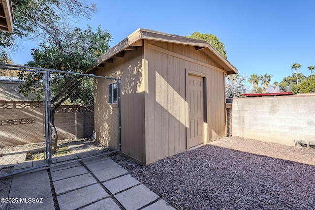 view of outbuilding featuring an outbuilding, a gate, and fence
