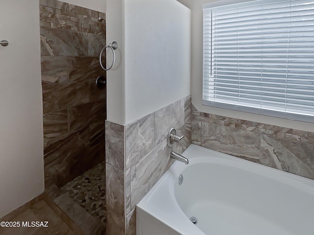 full bathroom featuring tiled shower and a garden tub