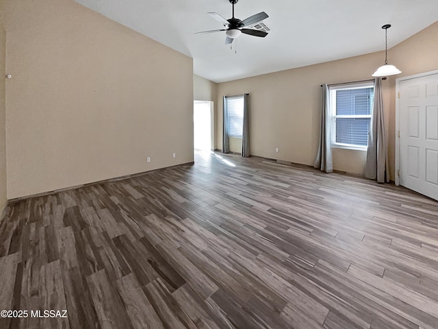 empty room featuring lofted ceiling, ceiling fan, and wood finished floors