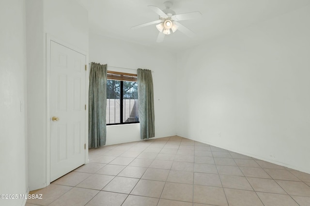 empty room featuring light tile patterned flooring and ceiling fan