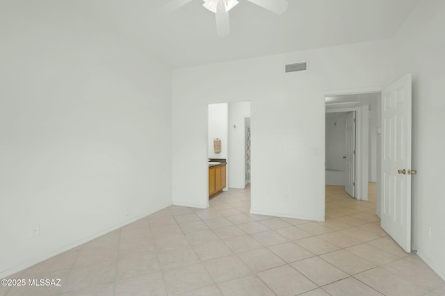 empty room featuring visible vents, ceiling fan, and light tile patterned floors