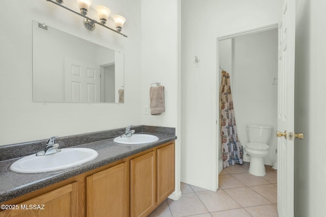 full bathroom featuring tile patterned flooring, a sink, toilet, and double vanity