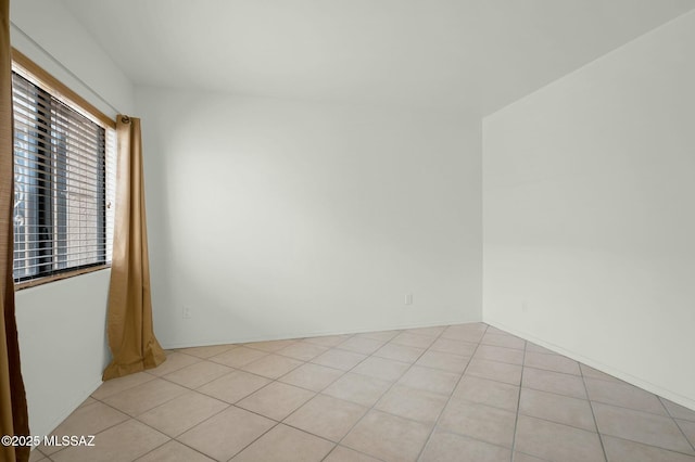 unfurnished room with light tile patterned flooring