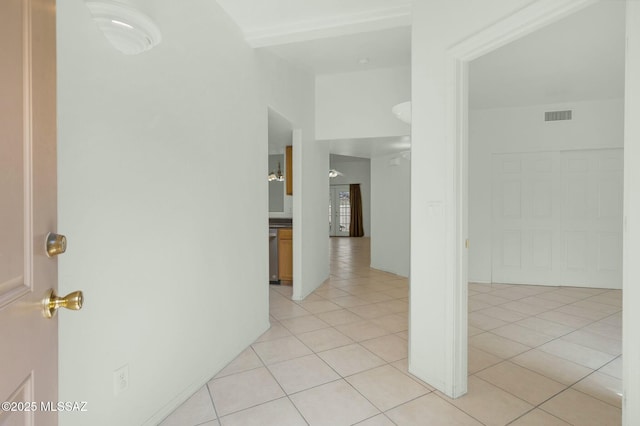 corridor featuring visible vents and light tile patterned floors