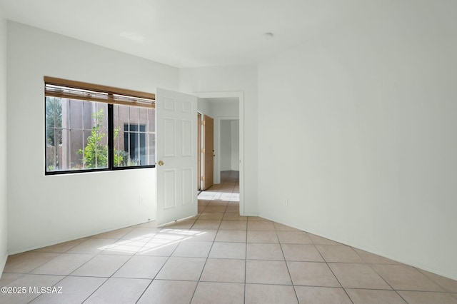 unfurnished room with light tile patterned flooring