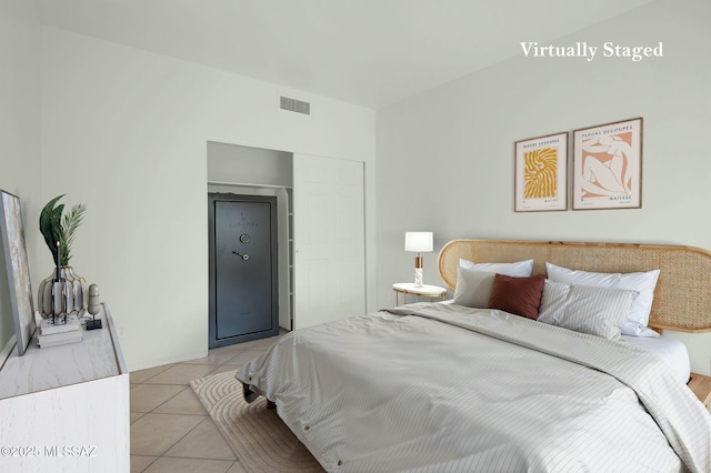 bedroom with visible vents and light tile patterned floors