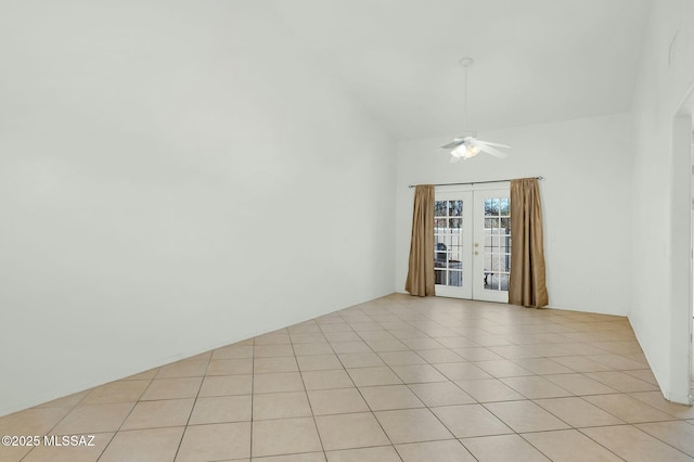 spare room featuring ceiling fan, vaulted ceiling, french doors, and light tile patterned floors