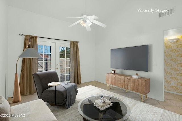 tiled living room featuring baseboards, visible vents, french doors, and a ceiling fan