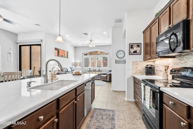kitchen with tasteful backsplash, black appliances, visible vents, ceiling fan, and a sink