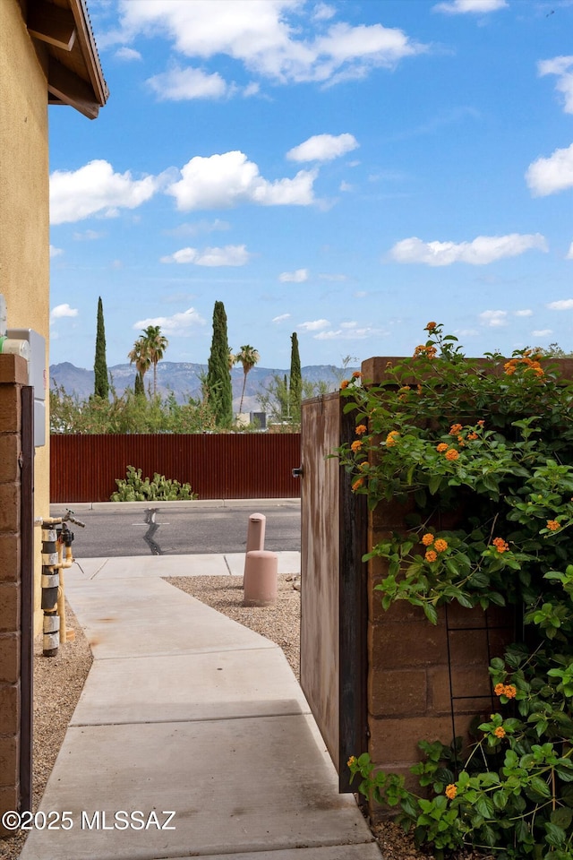 exterior space featuring a patio area, a mountain view, and fence