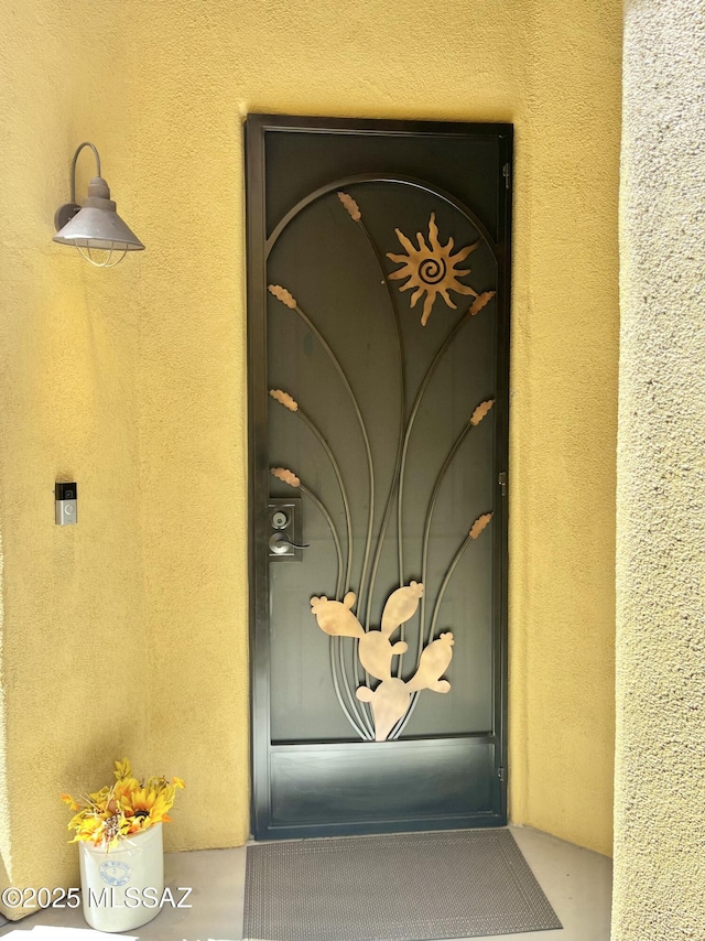 entrance to property featuring stucco siding