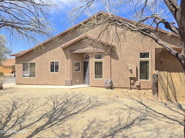 ranch-style house with an attached garage, stucco siding, and concrete driveway