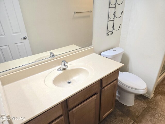 bathroom with toilet and vanity