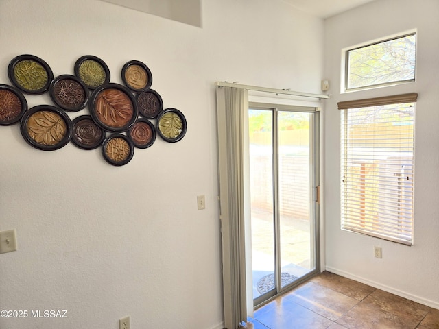 entryway with tile patterned floors and baseboards