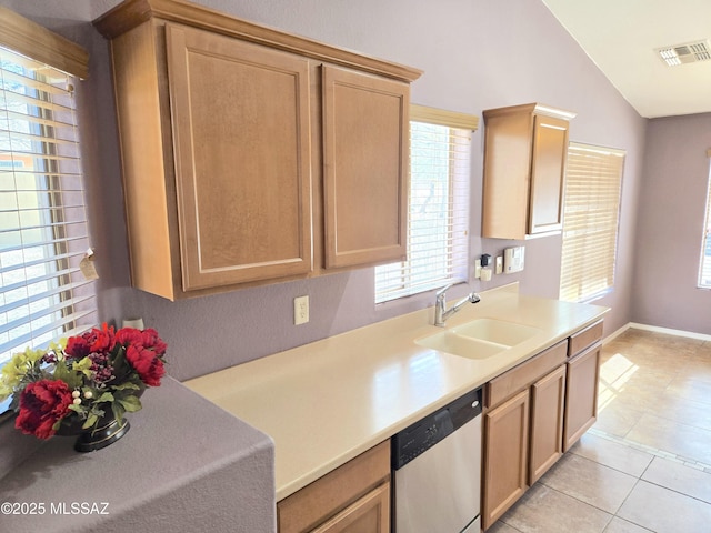 kitchen with stainless steel dishwasher, a sink, visible vents, light countertops, and light tile patterned floors
