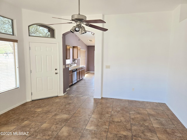 interior space with stone finish flooring, baseboards, and a ceiling fan