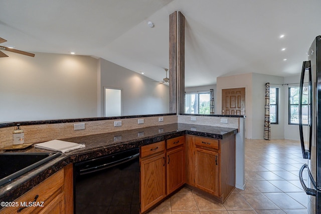 kitchen with a ceiling fan, tile countertops, black appliances, and vaulted ceiling