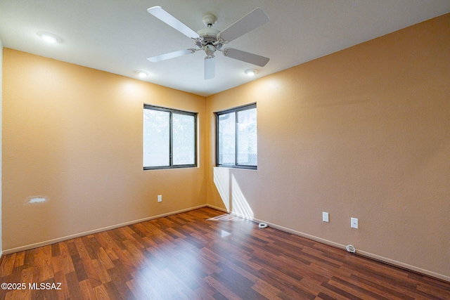 unfurnished room featuring a ceiling fan, baseboards, and wood finished floors