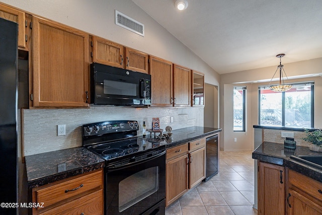 kitchen with tile countertops, visible vents, black appliances, and lofted ceiling