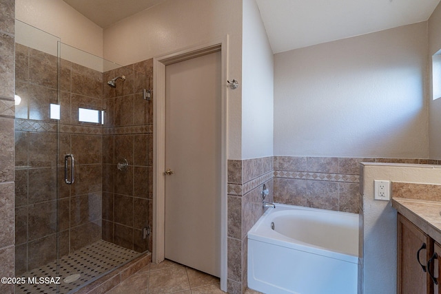 bathroom featuring a garden tub, tile patterned flooring, and a shower stall